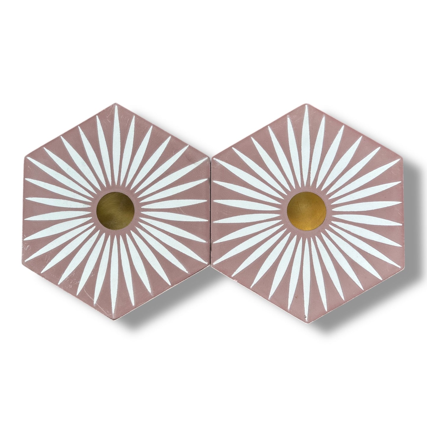 Two hexagonal tiles with sunburst pattern and gold center on a white background