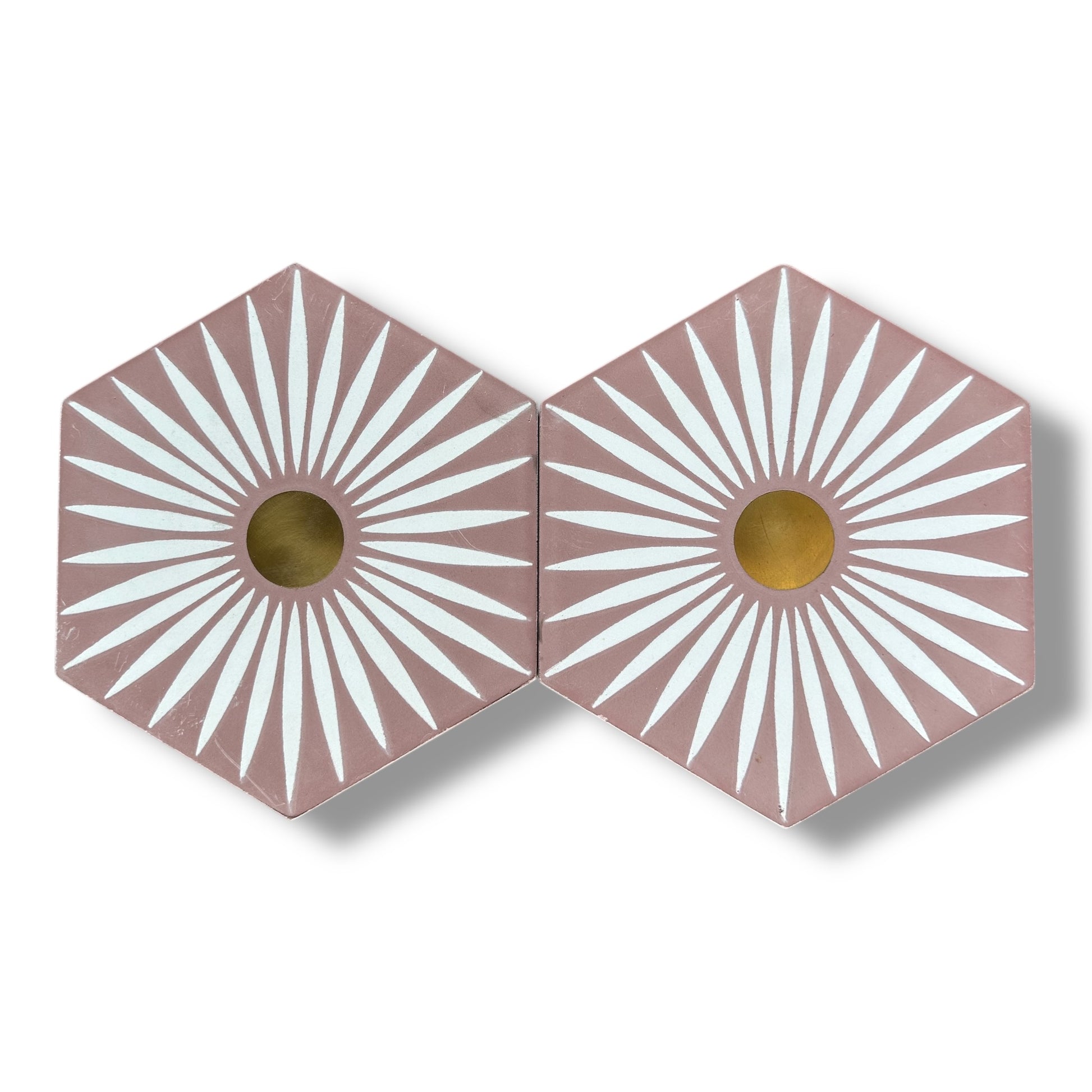 Two hexagonal tiles with sunburst pattern and gold center on a white background