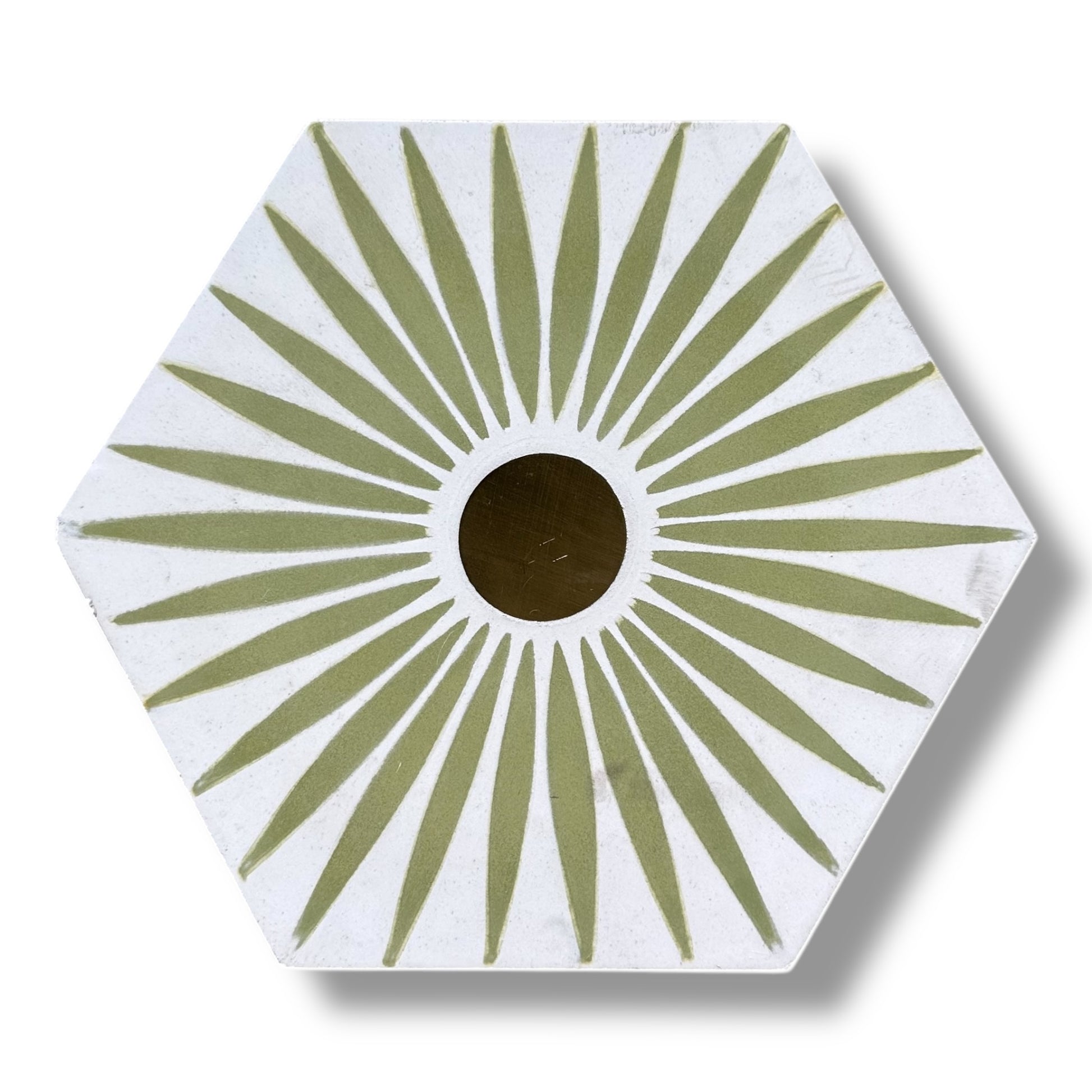 Hexagonal coaster with green sunburst pattern on a white background