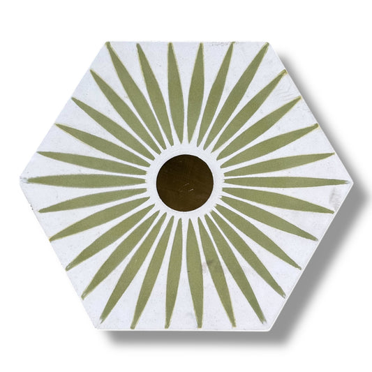 Hexagonal coaster with green sunburst pattern on a white background